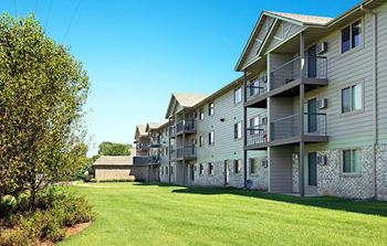 Apartment building with a green lawn in front.